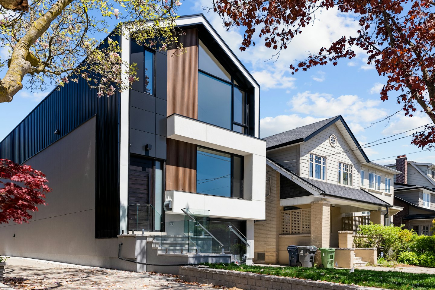 Modern house with dark metal and wood siding.